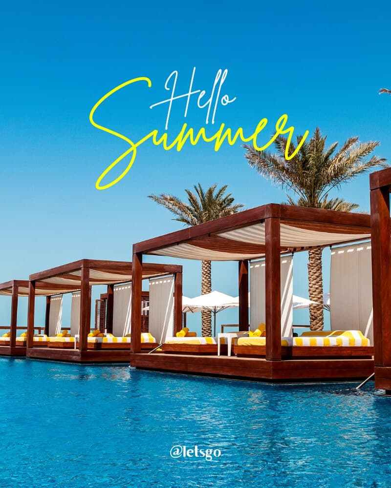 Luxury cabanas beside a bright blue resort pool